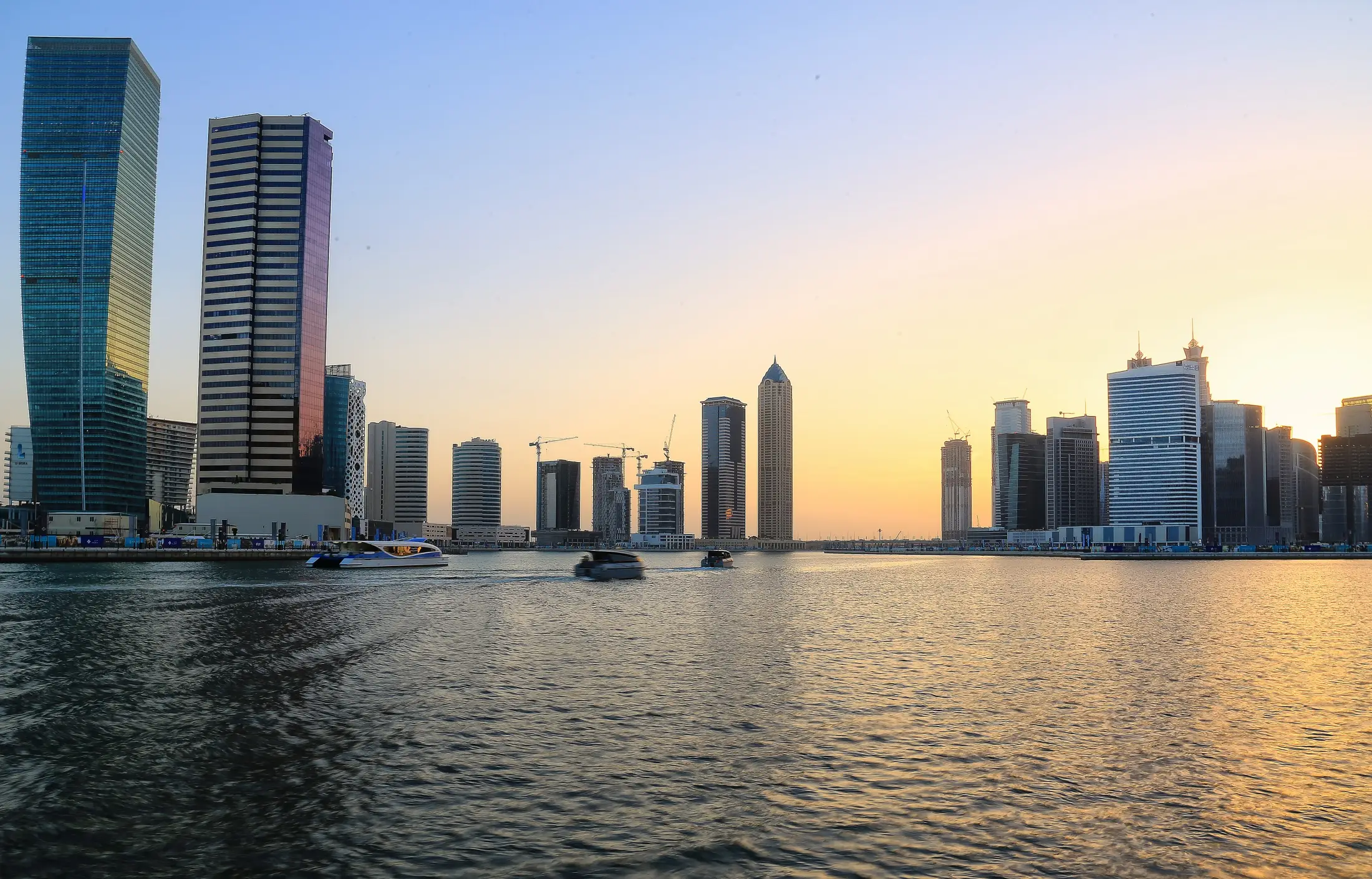 Business Bay towers along the Dubai Water Canal at sunset